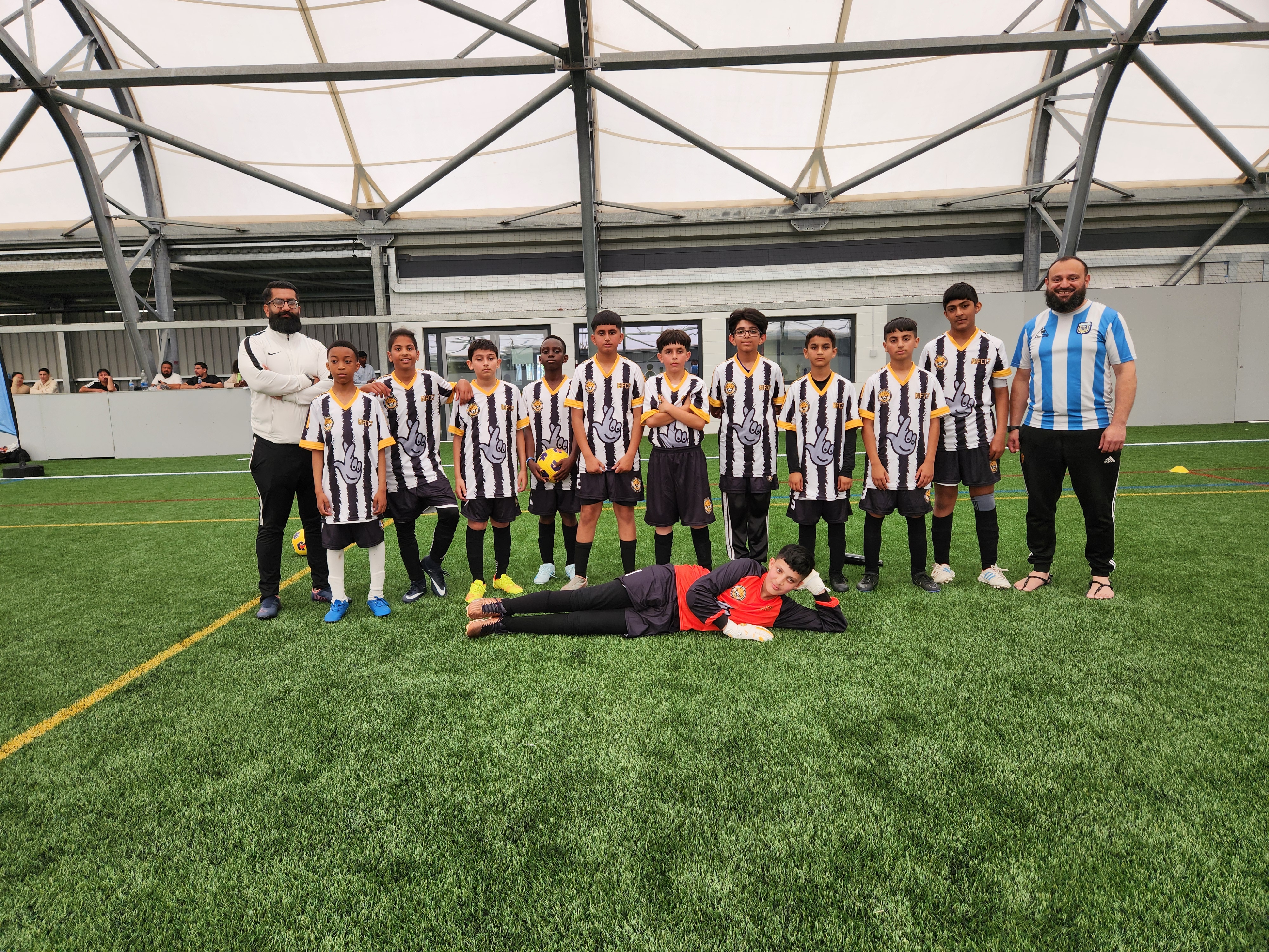 A diverse group of kids with their coach